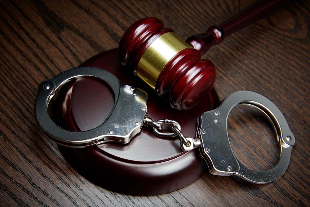 Gavel and handcuffs on wood in Rochester, New York